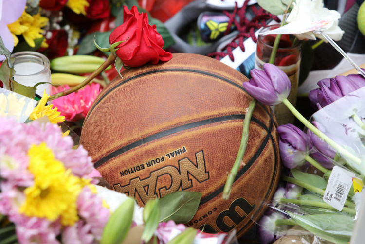Basketball amid flowers at shrine for former Los Angeles Lakers basketball star Kobe Bryant arrive at a makeshift shrine in Los Angeles, California, U.S. January 26, 2020.