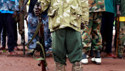 A former child soldier holds a gun as they participate in a child soldiers' release ceremony, outside Yambio, South Sudan