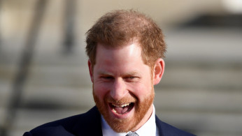 FILE PHOTO: Britain's Prince Harry attends a rugby event at Buckingham Palace gardens in London