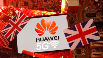 The British flag and a smartphone with a Huawei and 5G network logo are seen on a PC motherboard in this illustration picture