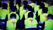 Employees of Tesla are seen during a delivery event for Tesla China-made Model 3 cars in Shanghai