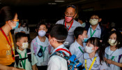 Guardians and students wear masks amid a health scare over a new virus that has infected thousands since emerging in China, in a Chinese school in Quezon City, Metro Manila, Philippines