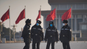 Police officers wearing masks are seen at at the Tiananmen Square, as the country is hit by an epidemic of the new coronavirus, in Beijing, China