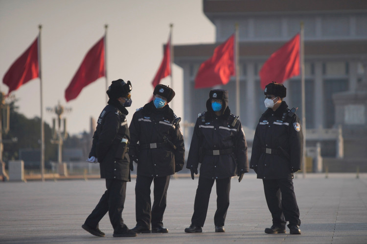 Police officers wearing masks are seen at at the Tiananmen Square, as the country is hit by an epidemic of the new coronavirus, in Beijing, China