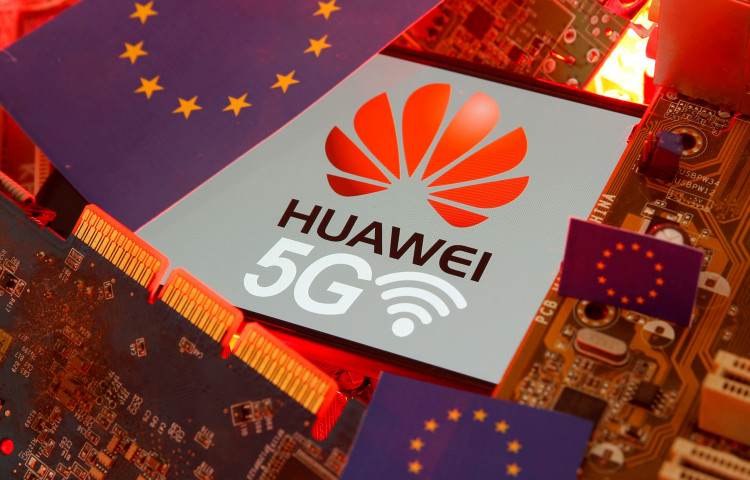 FILE PHOTO: The EU flag and a smartphone with the Huawei and 5G network logo are seen on a PC motherboard in this illustration