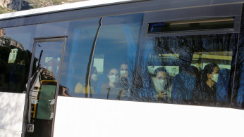 French citizens are seen on a bus as they arrive at the accommodation where they will be quarantined as preventive measure in light of the coronavirus outbreak in China