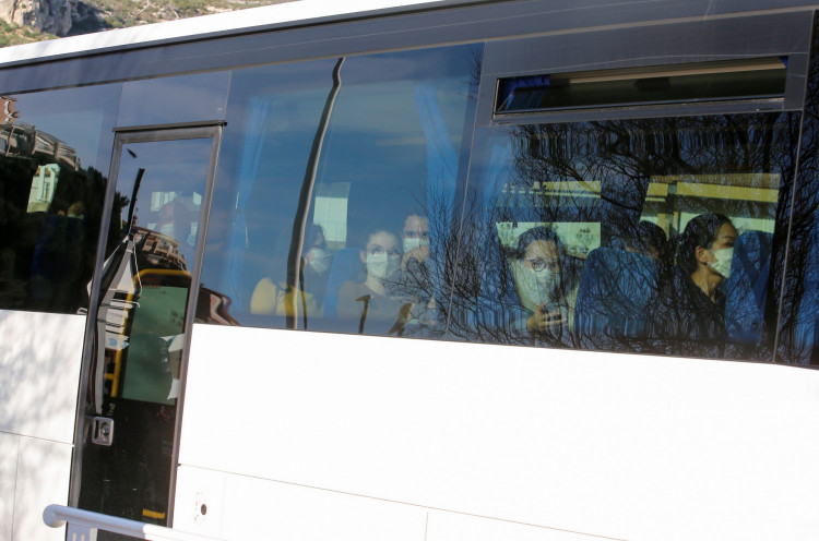 French citizens are seen on a bus as they arrive at the accommodation where they will be quarantined as preventive measure in light of the coronavirus outbreak in China