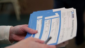An Iowa Caucus precinct worker counts Iowa Democratic Caucus paper ballots 