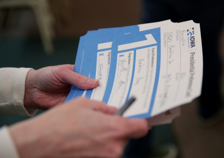 An Iowa Caucus precinct worker counts Iowa Democratic Caucus paper ballots 