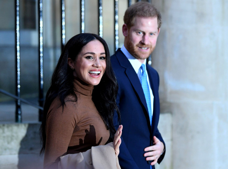 FILE PHOTO: Britain's Prince Harry and his wife Meghan, Duchess of Sussex react as they leave after their visit to Canada House in London, Britain January 7, 2020. Daniel Leal-Olivas/Pool via REUTERS/File Photo