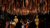 People stand by Oscar statues during a media preview of this year's Academy's Governors Ball in Los Angeles, California