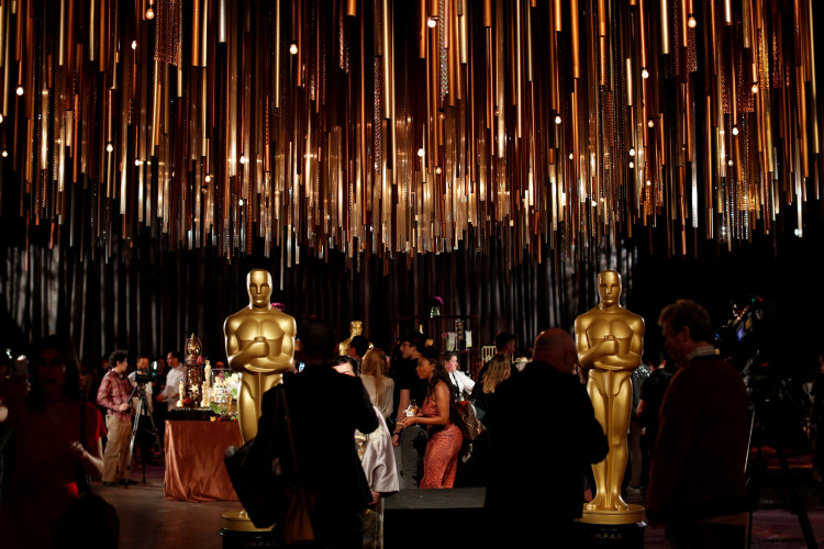 People stand by Oscar statues during a media preview of this year's Academy's Governors Ball in Los Angeles, California