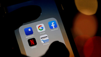 The logos of mobile apps, Google, Amazon, Facebook, Apple and Netflix, are displayed on a screen in this illustration picture