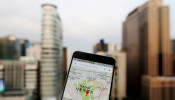 Google Maps application is displayed on a smartphone as central Seoul is seen in the background in Seoul, South Korea, in this photo illustration on August 24, 2016.