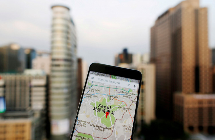 Google Maps application is displayed on a smartphone as central Seoul is seen in the background in Seoul, South Korea, in this photo illustration on August 24, 2016. 