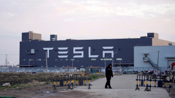 A Tesla sign is seen on the Shanghai Gigafactory of the U.S. electric car maker before a delivery ceremony in Shanghai, China January 7, 2020. 