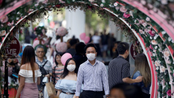 A couple celebrate Valentine's Day as they wear face masks in precaution of the coronavirus outbreak