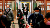 FILE PHOTO: People wear protective masks following the outbreak of a new coronavirus, during their morning commute in a station, in Hong Kong