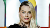 Cast member Margot Robbie poses as she arrives to attend the world premiere of 