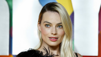 Cast member Margot Robbie poses as she arrives to attend the world premiere of 
