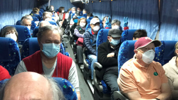 U.S. passengers on board the Diamond Princess cruise ship, who have chosen to leave, are transported by shuttle bus in Yokohama to Haneda airport to fly back to the United States via chartered evacuation aircraft, in Japan