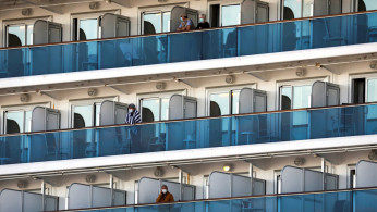 Passengers are seen on the cruise ship Diamond Princess, as the vessel's passengers continue to be tested for coronavirus, at Daikoku Pier Cruise Terminal in Yokohama, south of Tokyo