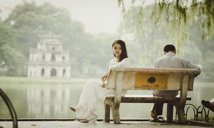 Woman sitting on bench outdoor.