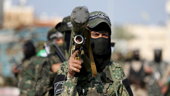Palestinian militants of the Al-Nasser Saladin Brigades take part in an anti-Israel military show in Khan Younis in the southern Gaza Strip