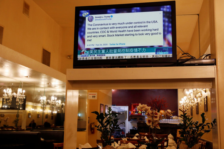 A tweet by U.S. Donald Trump regarding the coronavirus is seen on a Chinese television station inside a restaurant in the Chinatown section of San Francisco, California