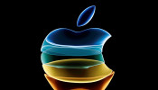 The Apple logo is displayed at an event at their headquarters in Cupertino
