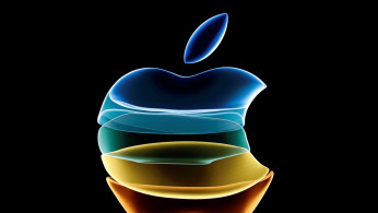The Apple logo is displayed at an event at their headquarters in Cupertino