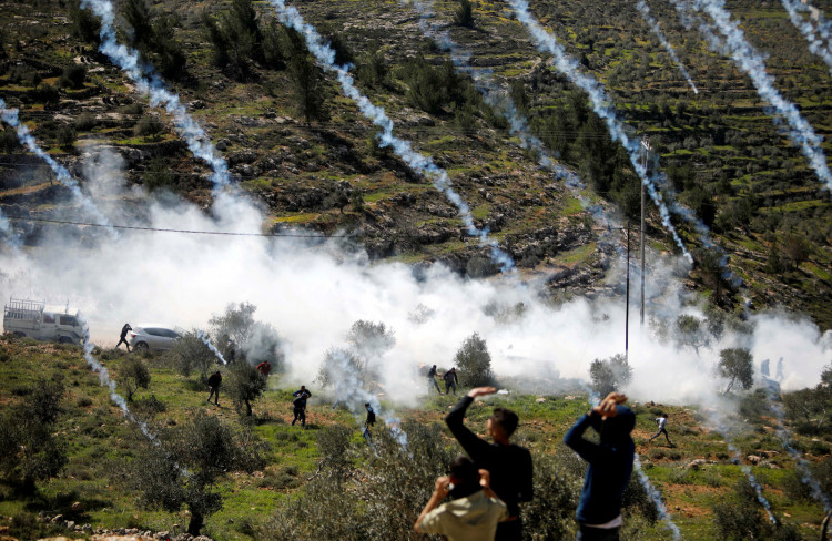 Tear gas canisters are fired by Israeli forces towards Palestinian demonstrators during a protest against Israeli settlements and Trump's Middle East peace plan, in Beita town in the Israeli-occupied West Bank