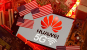 The U.S. flag and a smartphone with the Huawei and 5G network logo are seen on a PC motherboard in this illustration taken January 29, 2020. 