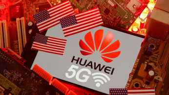 The U.S. flag and a smartphone with the Huawei and 5G network logo are seen on a PC motherboard in this illustration taken January 29, 2020. 