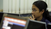 A broker looks at her computer terminal at a stock brokerage firm in Mumbai May 4, 2009.