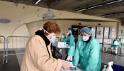 Medical workers wearing protective masks check patients at a medical checkpoint at the entrance of the Spedali Civili hospital in Brescia