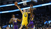 Golden State Warriors forward Alen Smailagic (6) shoots the ball between Los Angeles Lakers center Dwight Howard (39) and guard Troy Daniels (30)