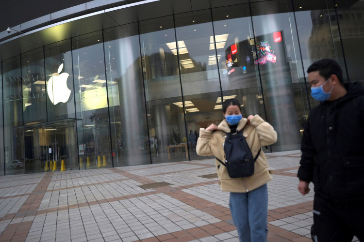 People wearing face masks are seen in front of an Apple Store, as the country is hit by an outbreak of the novel coronavirus, in Beijing