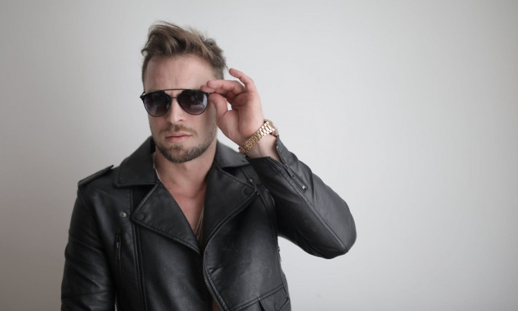 Man in leather wearing black glasses.