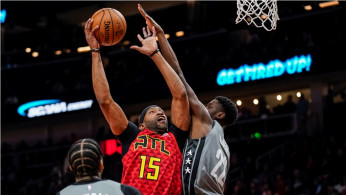 Atlanta Hawks guard Vince Carter (15) shoots over Brooklyn Nets guard Caris LeVert (22)
