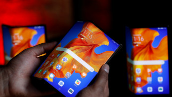 A Huawei employee demonstrates the features of the Huawei Mate XS device, during a media event in London
