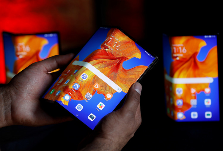 A Huawei employee demonstrates the features of the Huawei Mate XS device, during a media event in London