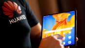 A Huawei employee demonstrates the features of the Huawei Mate XS device, during a media event in London