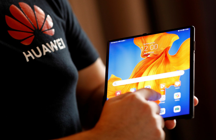 A Huawei employee demonstrates the features of the Huawei Mate XS device, during a media event in London