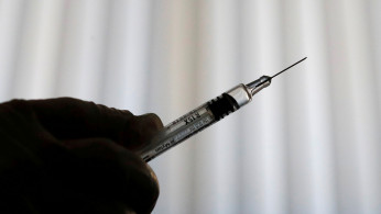 A doctor prepares a syringe as part of the start of the seasonal influenza vaccination campaign in Nice, France October 24, 2018. 