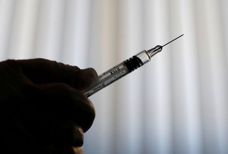 A doctor prepares a syringe as part of the start of the seasonal influenza vaccination campaign in Nice, France October 24, 2018. 