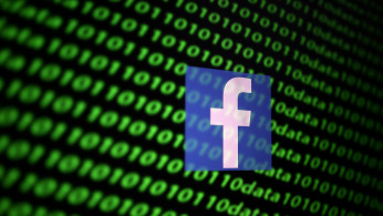 The Facebook logo and binary cyber codes are seen in this illustration taken November 26, 2019. 
