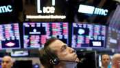 A trader works on the floor of the New York Stock Exchange shortly before the closing bell as the market takes a significant dip in New York