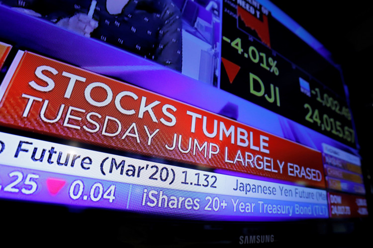 Stock market updates are seen on a news broadcast on the floor of the New York Stock Exchange (NYSE) in New York City, New York