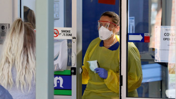 A nurse speaks with patients at the door of a new coronavirus disease (COVID-19) clinic opening at Mount Barker Hospital in Adelaide